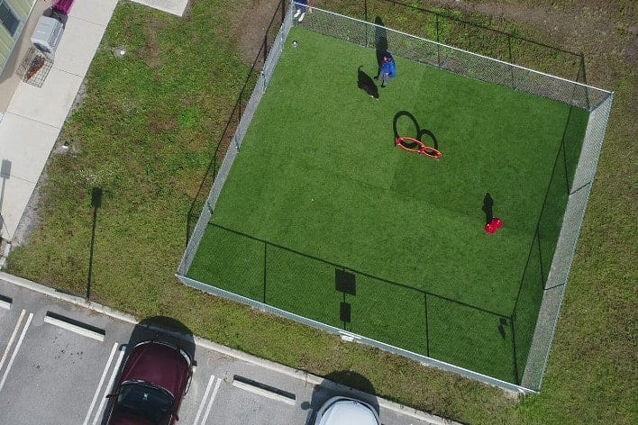 Drone shot of commercial artificial pet grass dog park